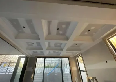 Coffered ceiling installation in Paddington with decorative trim panels framed before touch-ups