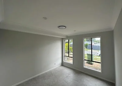 Completed plastering in Carseldine with smooth walls and ceiling finished with cornice trim