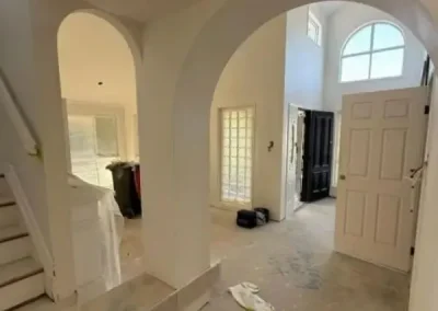 Decorative archway plastering in Fig Tree Pocket with a double-height entry and staircase finished smooth