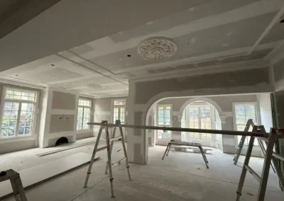 Decorative ceiling rose and archway plastering in St Lucia with multiple windows jointed before final coat