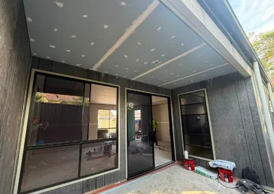 Exterior ceiling plasterboard installation in Corinda with eave sheeting jointed above a patio entry