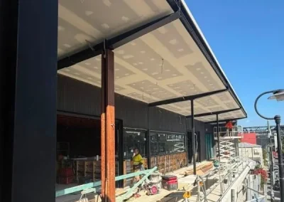Exterior ceiling plasterboard installation in Rochedale with a cantilevered awning fitted above outdoor seating