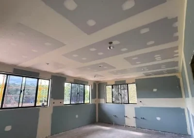 Plastering services in Rochedale with ceiling joints taped across a row of windows before sanding